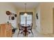 Cozy breakfast nook featuring a round wooden table and a window with floral valance at 3003 Heavenly Ln, Snellville, GA 30078