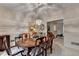 Formal dining room featuring an oval wood table set for six and classic chandelier at 3003 Heavenly Ln, Snellville, GA 30078