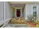 Inviting entryway with stone steps and a red front door at 3003 Heavenly Ln, Snellville, GA 30078