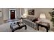 Cozy living room featuring a striped sofa, glass tables, and carpeted floors at 3003 Heavenly Ln, Snellville, GA 30078