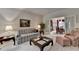 Comfortable living room with classic furnishings and view to dining room at 3003 Heavenly Ln, Snellville, GA 30078