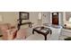 Elegant living room with a cozy armchair, striped sofa, and glass coffee table at 3003 Heavenly Ln, Snellville, GA 30078