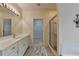Bright bathroom featuring a vanity and a large walk-in closet at 3003 Heavenly Ln, Snellville, GA 30078