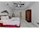 The main bedroom offers a ceiling fan and plush bed, complemented by stylish decor and ample space at 3003 Heavenly Ln, Snellville, GA 30078