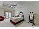 Spacious main bedroom with a tray ceiling, ceiling fan, and a plush bed, providing an inviting and relaxing atmosphere at 3003 Heavenly Ln, Snellville, GA 30078