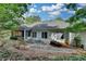 Back exterior featuring an enclosed porch and natural landscaping at 3003 Heavenly Ln, Snellville, GA 30078