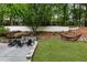 Backyard with a large deck, seating area, landscaped gardens, and a hammock at 310 Tradea Tarn, Roswell, GA 30076