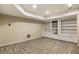 Finished basement featuring built in shelving and cabinets plus neutral carpet at 310 Tradea Tarn, Roswell, GA 30076