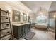 Elegant bathroom boasts a double vanity, soaking tub, and decorative chandelier at 310 Tradea Tarn, Roswell, GA 30076