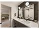 Chic bathroom showcases a modern vanity, unique mirrors, and sliding barn door at 310 Tradea Tarn, Roswell, GA 30076