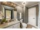 Well-lit bathroom featuring granite countertop, patterned shower curtain, and unique mirror at 310 Tradea Tarn, Roswell, GA 30076