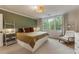 Cozy bedroom with a window, ladder style shelving and wood chair at 310 Tradea Tarn, Roswell, GA 30076