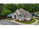 Exterior view of clubhouse featuring well-maintained lawn and pool at 310 Tradea Tarn, Roswell, GA 30076