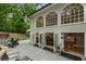 Home exterior featuring large arched windows and access to a wooden deck at 310 Tradea Tarn, Roswell, GA 30076