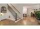 Foyer featuring hardwood floors, staircase, and built-in shelving at 310 Tradea Tarn, Roswell, GA 30076