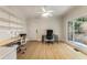 Bright office space with built-in shelving, ample workspace, and a large window overlooking the yard at 310 Tradea Tarn, Roswell, GA 30076