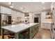 Modern kitchen with white cabinets, a spacious island, and stainless steel appliances offers a sleek design at 310 Tradea Tarn, Roswell, GA 30076