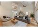 Spacious living room with a fireplace, balcony, hardwood floors, and large windows offering a view of the backyard at 310 Tradea Tarn, Roswell, GA 30076