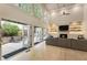 Bright living room with a fireplace, custom shelving, hardwood floors, and French doors to an outdoor patio at 310 Tradea Tarn, Roswell, GA 30076