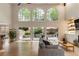 Bright, open living room features hardwood floors, high ceilings, and french doors to the back patio at 310 Tradea Tarn, Roswell, GA 30076