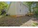 Exterior view of backyard with deck and two-story home with light beige siding at 785 Redland Dr, Jonesboro, GA 30238