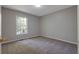 Cozy bedroom with plush carpeting, a bright window, and neutral paint for a peaceful retreat at 785 Redland Dr, Jonesboro, GA 30238
