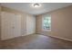 Bedroom with carpet features double closets and a window offering natural light at 785 Redland Dr, Jonesboro, GA 30238