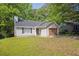 Charming single-story home with vinyl siding, an attached garage, and a well-maintained front yard at 785 Redland Dr, Jonesboro, GA 30238