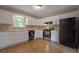 Bright kitchen with white cabinets, stainless steel appliances, and a tiled backsplash at 785 Redland Dr, Jonesboro, GA 30238