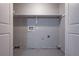Unfinished laundry room with utility hookups and shelf ready for customization at 785 Redland Dr, Jonesboro, GA 30238