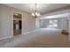 Spacious living room features vaulted ceilings, neutral paint colors, and plush carpet at 785 Redland Dr, Jonesboro, GA 30238
