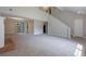 Open-concept living room features a fireplace, soaring ceilings, and plush carpet at 785 Redland Dr, Jonesboro, GA 30238