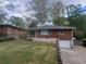 Charming brick home featuring an attached single-car garage and well-maintained front lawn at 1230 Lloyd Dr, Forest Park, GA 30297