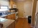 Well-lit kitchen featuring wooden cabinets, modern appliances, and tile backsplash at 1230 Lloyd Dr, Forest Park, GA 30297