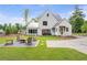 Expansive backyard with a fire pit, outdoor seating, and a well-manicured lawn at 12520 Celestine Way, Milton, GA 30075