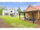 Expansive backyard with a covered patio and outdoor seating area, perfect for entertaining next to the modern home at 12520 Celestine Way, Milton, GA 30075