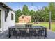 Elegant backyard patio with a dining area and fire pit, perfect for outdoor gatherings and relaxation at 12520 Celestine Way, Milton, GA 30075