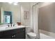 Bright bathroom with sleek vanity, white tiled shower and tub, and modern fixtures for a stylish space at 12520 Celestine Way, Milton, GA 30075