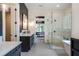 Contemporary bathroom featuring a glass shower, vanity and double sinks, and decorative lighting at 12520 Celestine Way, Milton, GA 30075