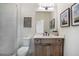 Modern bathroom showcasing a stylish vanity, and a sleek faucet, complemented by a framed piece of artwork at 12520 Celestine Way, Milton, GA 30075