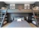 Stylized bedroom with custom built-in bunk beds with storage, grey horizontal paneling and matching modern decor at 12520 Celestine Way, Milton, GA 30075