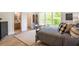 Cozy bedroom with natural light, wood floors, and a view to the trees, creating a calming atmosphere at 12520 Celestine Way, Milton, GA 30075