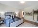 Comfortable bedroom with a metal bed frame, neutral decor, and ample natural light creates a relaxing retreat at 12520 Celestine Way, Milton, GA 30075