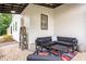 Cozy covered patio featuring comfortable seating, a coffee table, and a view of the yard at 12520 Celestine Way, Milton, GA 30075