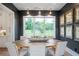 Dining room featuring a large window, botanical prints, and a round wooden table with seating at 12520 Celestine Way, Milton, GA 30075