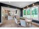 Dining area featuring a large window with views of the property and dark accent wall at 12520 Celestine Way, Milton, GA 30075