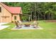 Inviting outdoor fire pit area with Adirondack chairs, perfect for entertaining and relaxing at 12520 Celestine Way, Milton, GA 30075