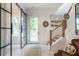 Elegant foyer with a staircase and glass sliding door, providing ample natural light and a modern touch at 12520 Celestine Way, Milton, GA 30075