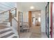 Inviting foyer with a staircase, stylish chair, and a glimpse into the open-concept living space at 12520 Celestine Way, Milton, GA 30075