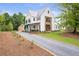 Beautiful modern farmhouse featuring a long gravel driveway leading to a well-maintained yard at 12520 Celestine Way, Milton, GA 30075